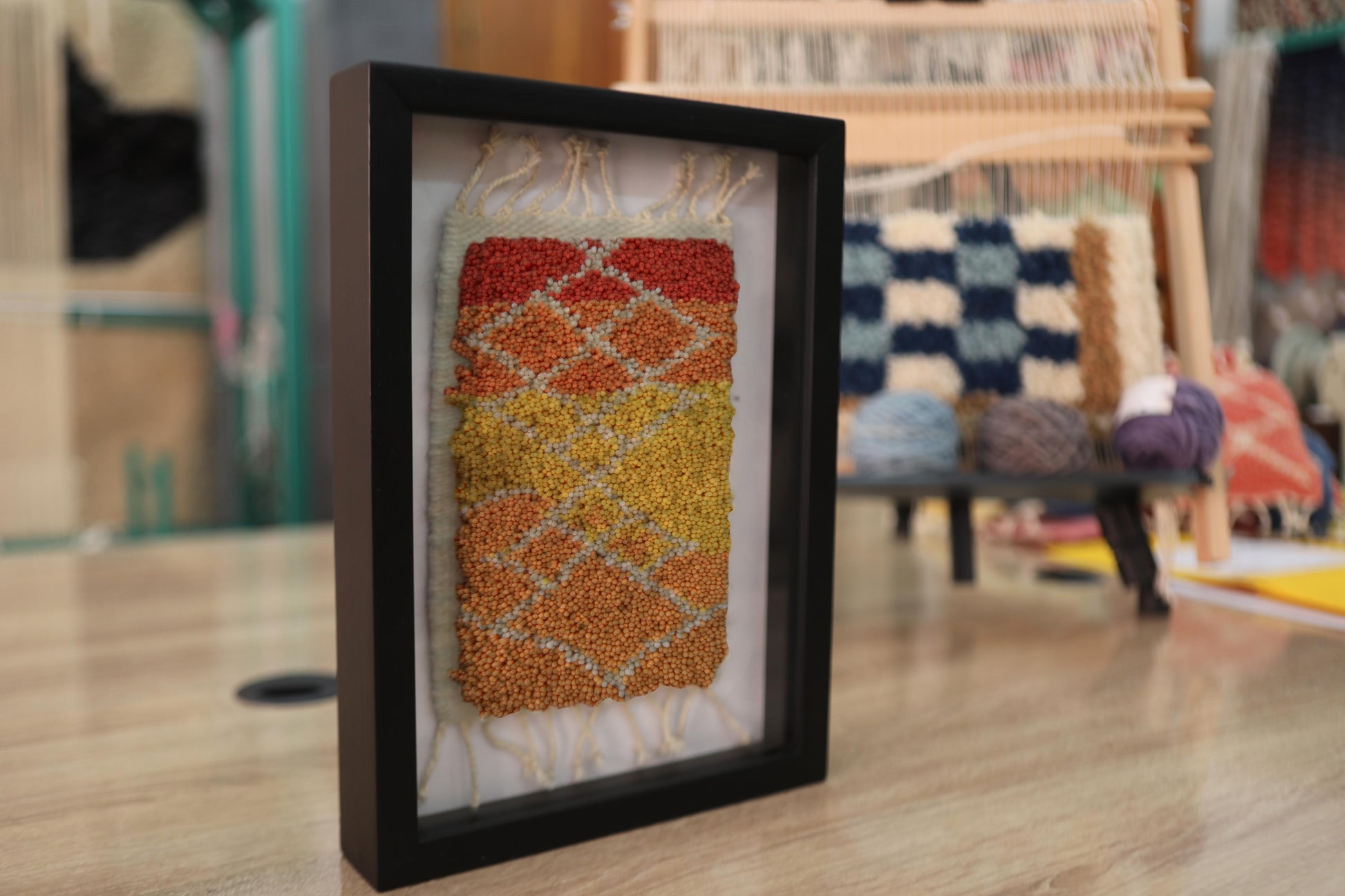 sunset moroccan rug, framed moroccan wall art, diamond moroccan tapestry, boho home decor, hand knotted mini rug, warm color moroccan textile, knot by knot wool art, moroccan rug 25x31 cm, artisanal wool wall hanging, orange yellow red rug art
