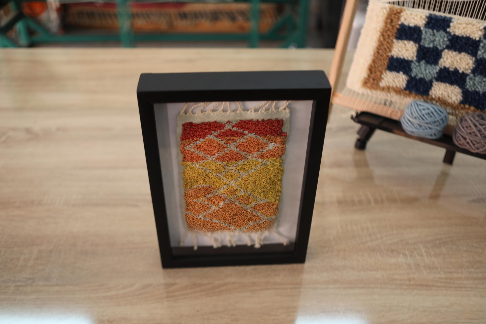 sunset moroccan rug, framed moroccan wall art, diamond moroccan tapestry, boho home decor, hand knotted mini rug, warm color moroccan textile, knot by knot wool art, moroccan rug 25x31 cm, artisanal wool wall hanging, orange yellow red rug art

