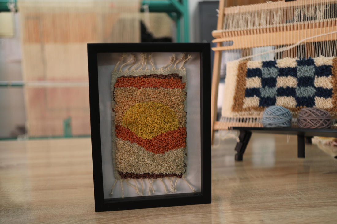 sunset moroccan rug art, moroccan mini rug, hand knotted wall hanging, framed rug decor, abstract sun textile, boho rug wall art, earth tone moroccan rug, artisanal wool weaving, moroccan rug knot by knot, 25x31 cm framed rug