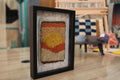 sunset moroccan rug art, moroccan mini rug, hand knotted wall hanging, framed rug decor, abstract sun textile, boho rug wall art, earth tone moroccan rug, artisanal wool weaving, moroccan rug knot by knot, 25x31 cm framed rug