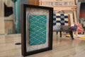 turquoise wall art, diamond pattern rug, moroccan rug, hand-knotted textile, geometric moroccan decor, framed wool wall hanging, handmade moroccan rug art, mini turquoise rug, boho diamond wall piece, knot by knot weaving
